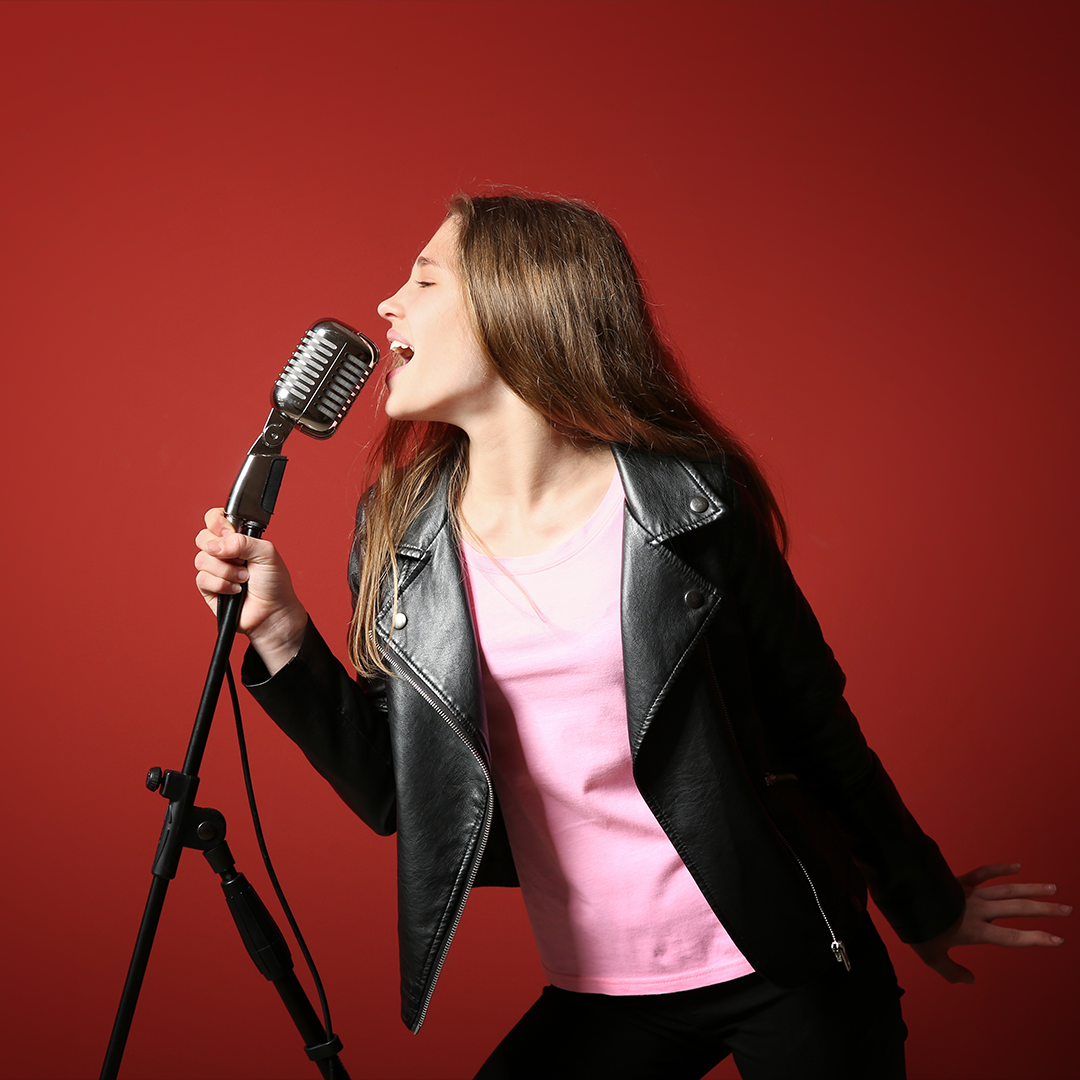 Girl singing into microphone.