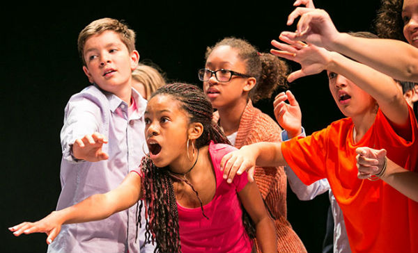 Young actors practicing improvisation poses.