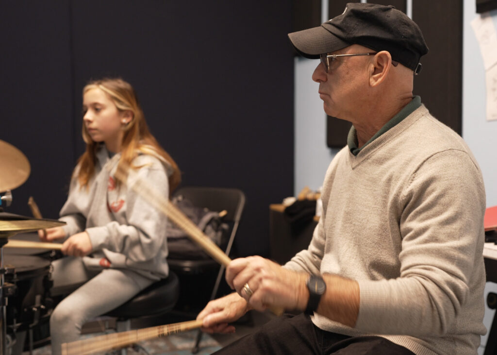 Drum teacher John Csorba teaching young student during drum lesson.