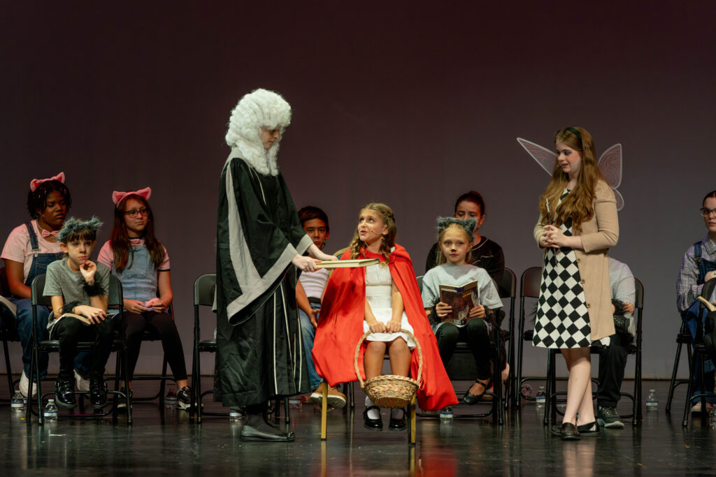 Judge Old Wise Man swearing in Little Red Riding Hood during questioning in The Big Bad Musical.